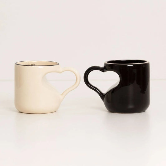 Set of two mugs with heart-shaped handles.